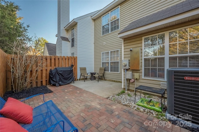 view of patio featuring central AC and fence