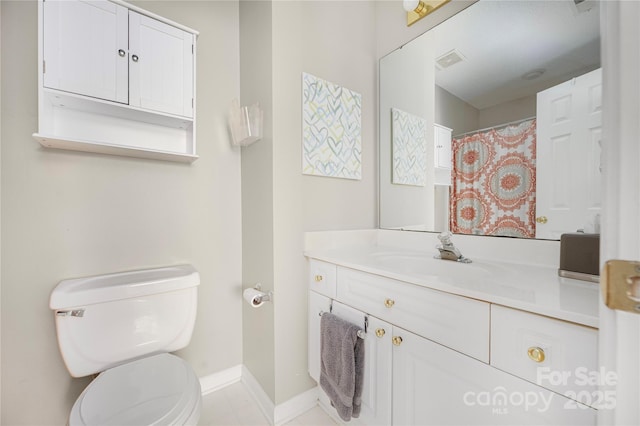 bathroom with toilet, baseboards, visible vents, and vanity