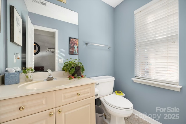 bathroom featuring visible vents, vanity, and toilet