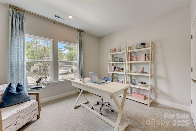 carpeted home office with baseboards and visible vents