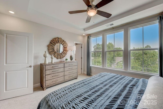 bedroom featuring visible vents, baseboards, a raised ceiling, recessed lighting, and light colored carpet