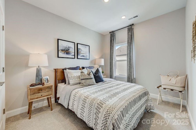 bedroom featuring visible vents, baseboards, and light colored carpet