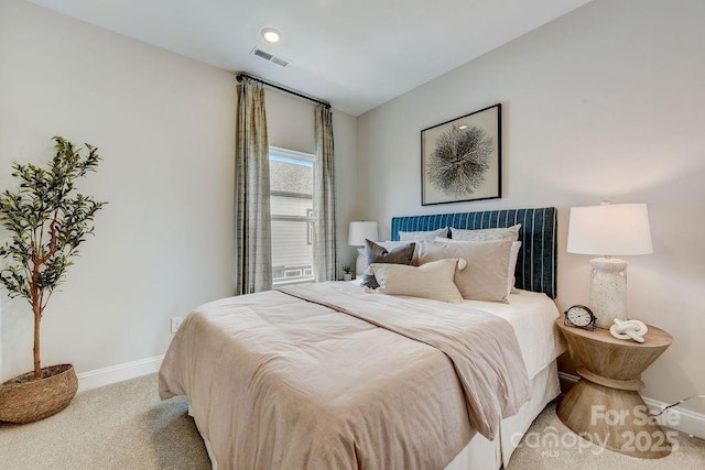 bedroom featuring light colored carpet, baseboards, and visible vents