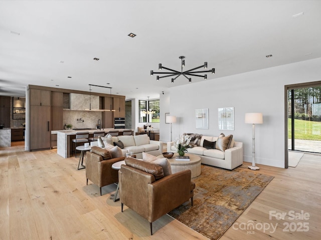 living room featuring light wood finished floors and baseboards