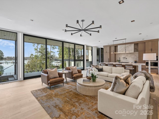 living area with expansive windows and light wood-type flooring