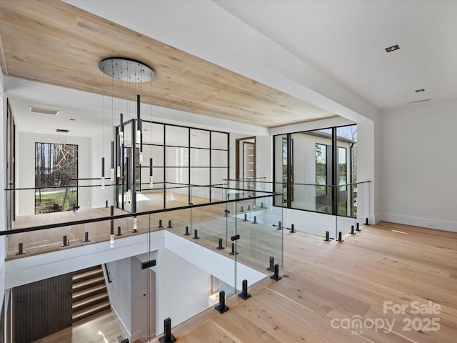 interior space featuring baseboards, visible vents, and light wood-style floors