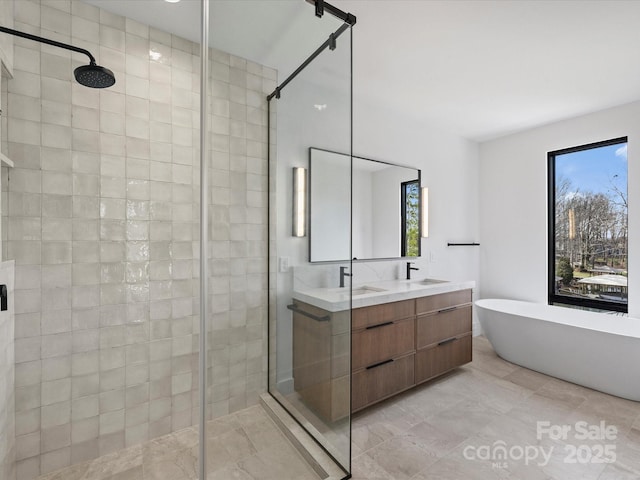 full bathroom with double vanity, a soaking tub, and a shower stall