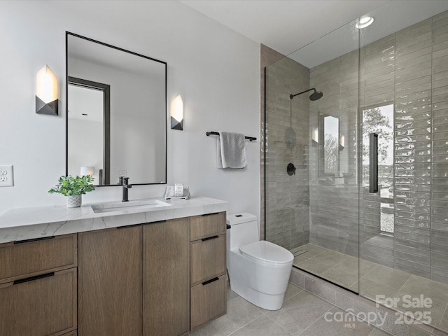 bathroom featuring toilet, tile patterned flooring, a tile shower, and vanity