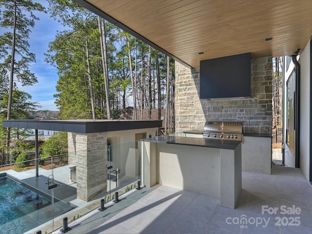 view of patio / terrace featuring a balcony, a grill, and area for grilling