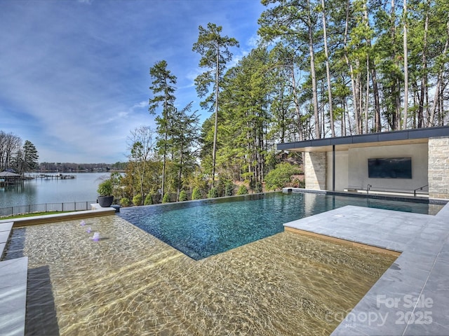 view of pool with a water view, an infinity pool, and a patio