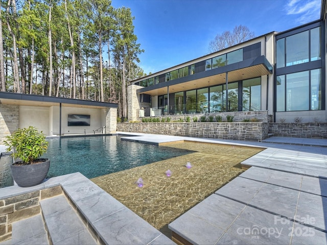 outdoor pool with a patio area