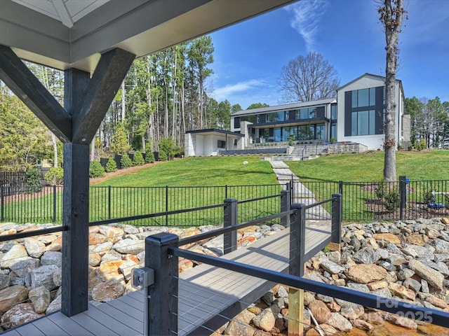 deck featuring a lawn and fence