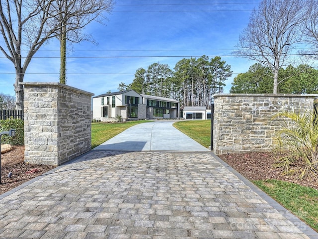 view of gate with a yard