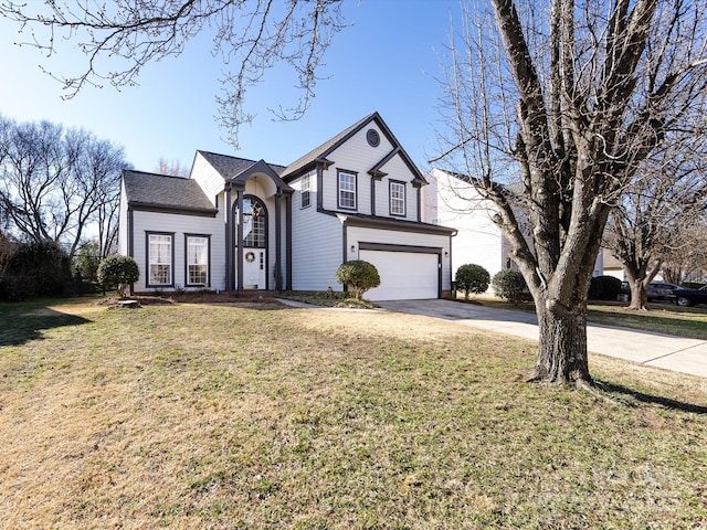 traditional-style home with a garage, concrete driveway, and a front yard