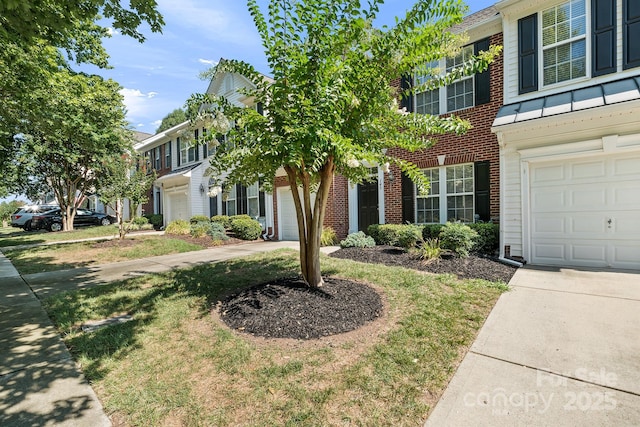 view of front of house with driveway and brick siding