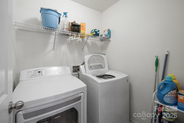 clothes washing area with laundry area and washer and clothes dryer