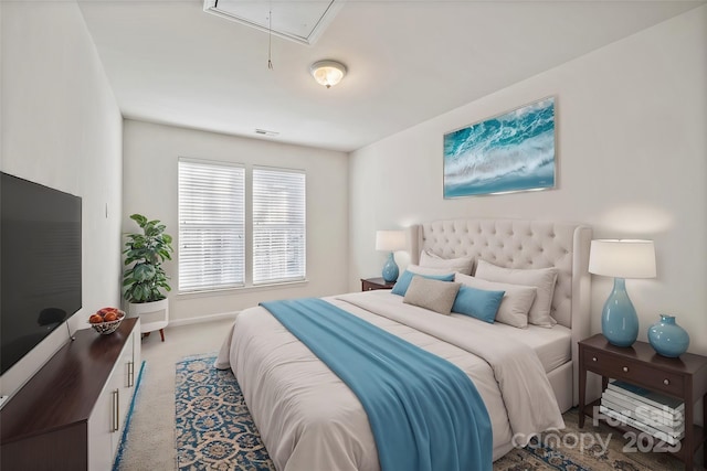 bedroom with attic access, visible vents, baseboards, and light colored carpet