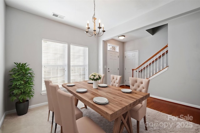 dining space with stairway, baseboards, visible vents, and a notable chandelier