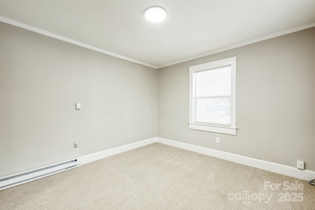 spare room with a baseboard heating unit, carpet, crown molding, and baseboards