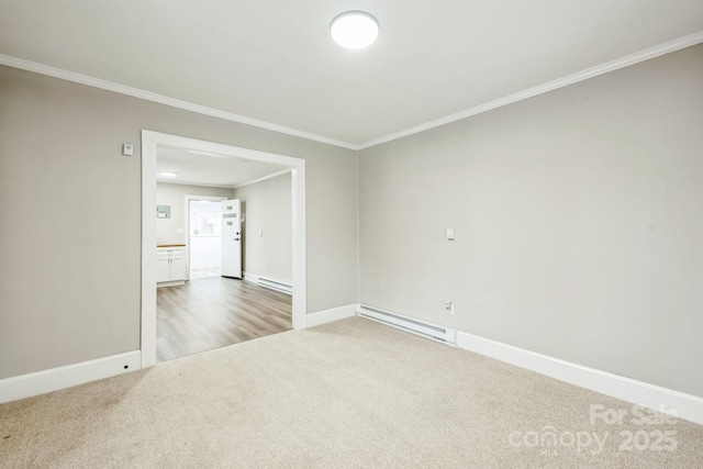 empty room with ornamental molding, a baseboard radiator, carpet flooring, and baseboards