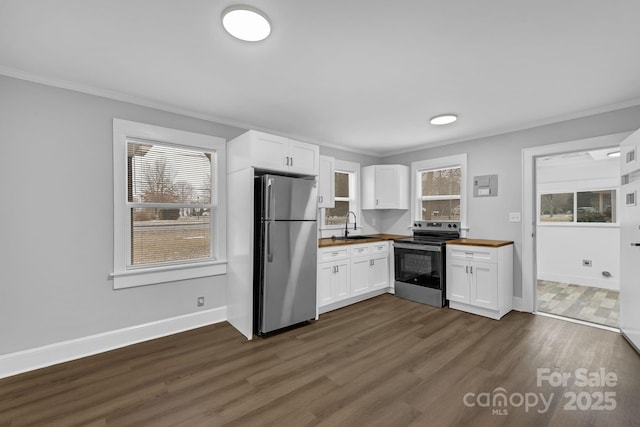 kitchen featuring dark wood-style floors, butcher block counters, appliances with stainless steel finishes, white cabinetry, and a sink