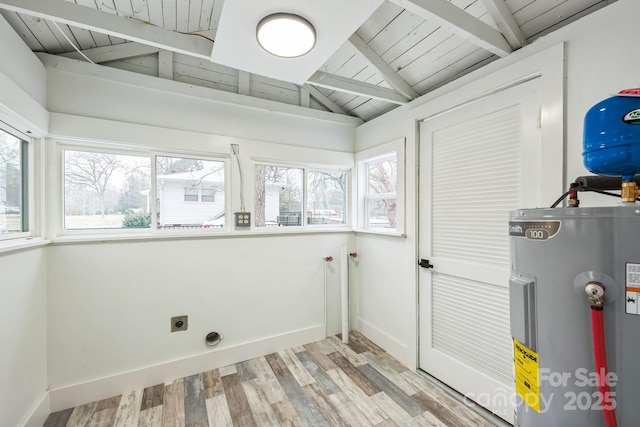 laundry area with water heater, laundry area, electric dryer hookup, and baseboards