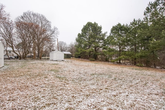 view of yard with a storage shed and an outdoor structure