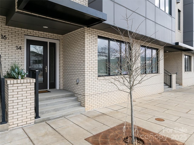 property entrance with brick siding