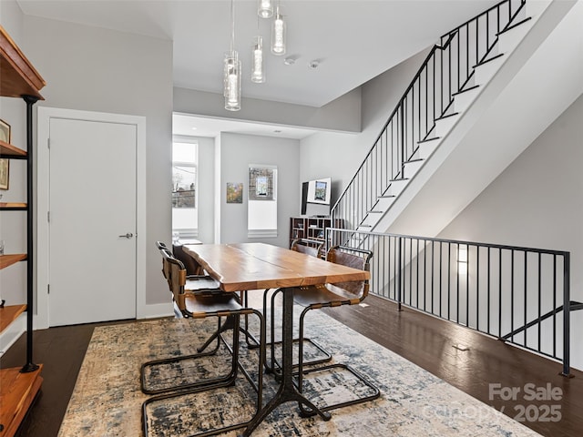 dining space featuring stairway and dark wood finished floors