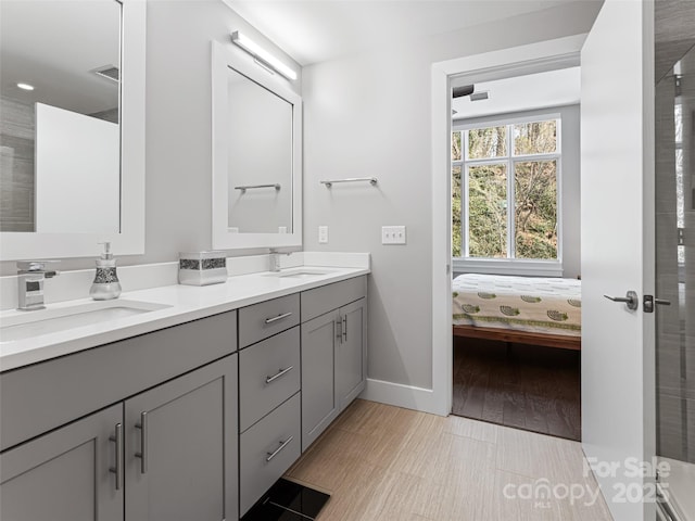 ensuite bathroom featuring double vanity, visible vents, a sink, and ensuite bathroom