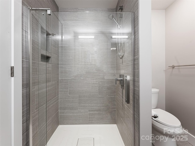 bathroom featuring a stall shower and toilet