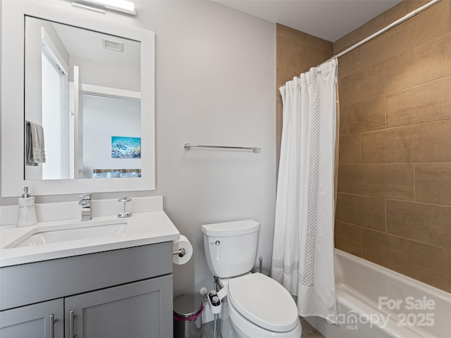 bathroom with shower / bath combo, vanity, and toilet