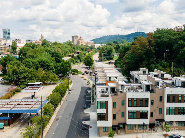 drone / aerial view with a mountain view and a city view