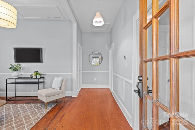 entrance foyer featuring wood finished floors, visible vents, and baseboards