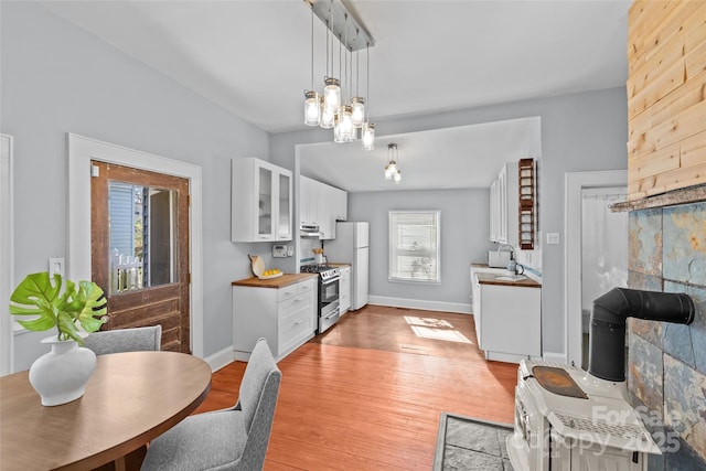 dining room with light wood-style floors, baseboards, and an inviting chandelier