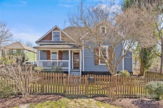 view of front facade featuring a porch and a fenced front yard