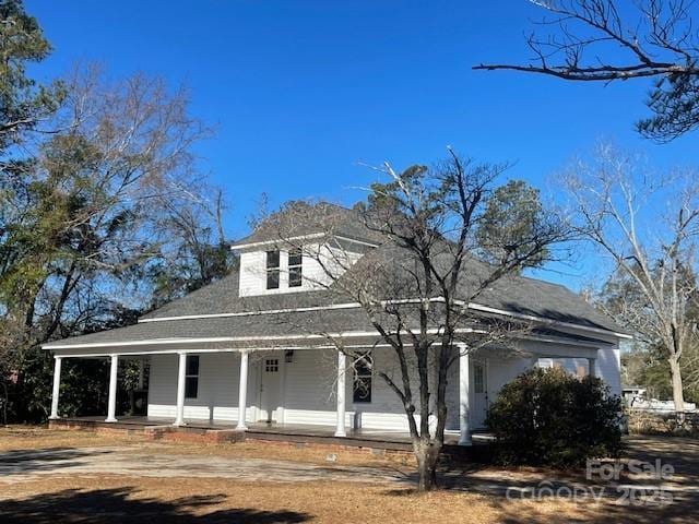 farmhouse-style home featuring covered porch