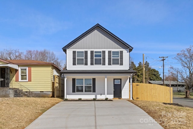 view of front of property with board and batten siding and fence