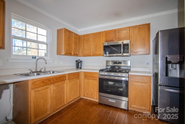 kitchen with stainless steel appliances, dark wood-type flooring, a sink, and ornamental molding