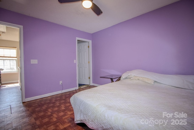 bedroom with baseboards and a ceiling fan