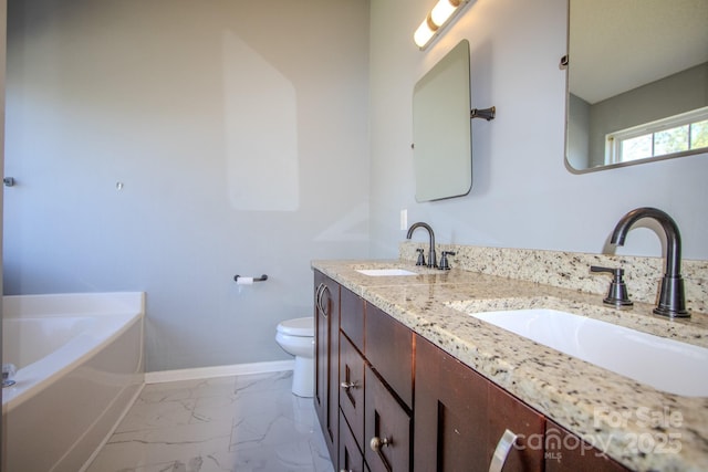 bathroom with toilet, marble finish floor, baseboards, and a sink