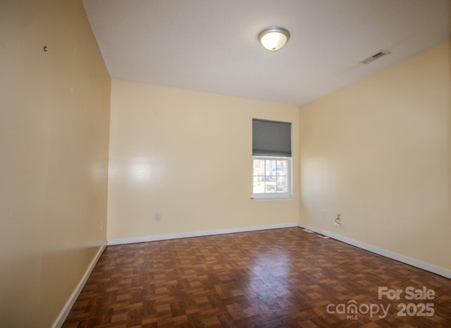 empty room with baseboards and visible vents