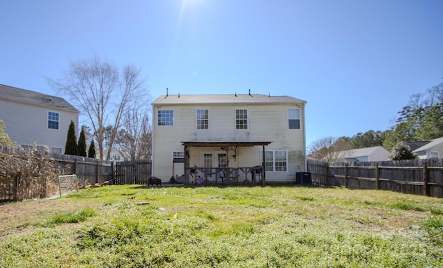 back of property featuring a fenced backyard, a yard, and a patio