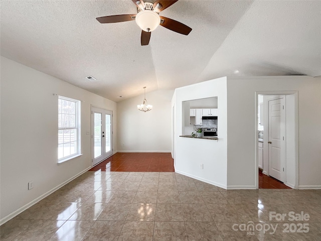 unfurnished living room with visible vents, lofted ceiling, french doors, tile patterned floors, and a textured ceiling