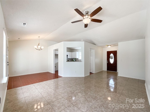 unfurnished living room with visible vents, ceiling fan with notable chandelier, baseboards, and vaulted ceiling