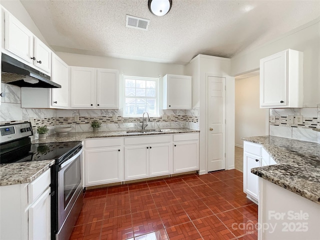 kitchen featuring visible vents, stainless steel electric stove, a sink, white cabinets, and under cabinet range hood