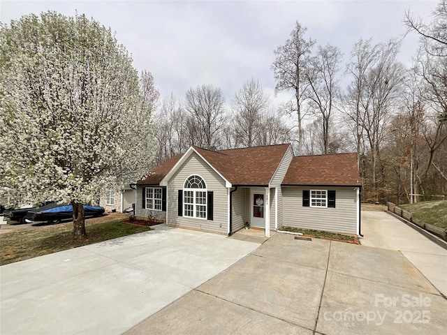 ranch-style house with roof with shingles