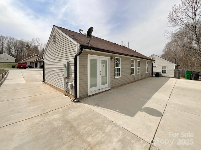 back of house featuring cooling unit and french doors