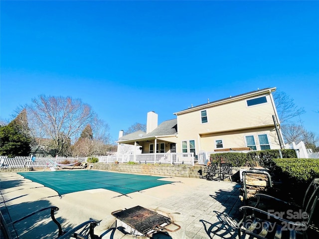 view of pool with a patio area, fence, and a fenced in pool