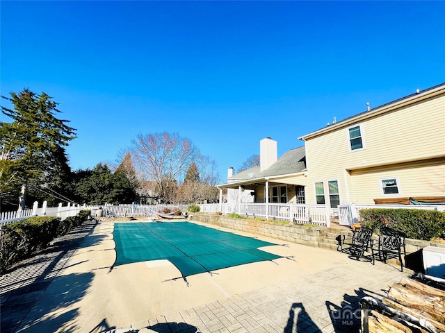 view of pool with a fenced in pool, a patio, and fence